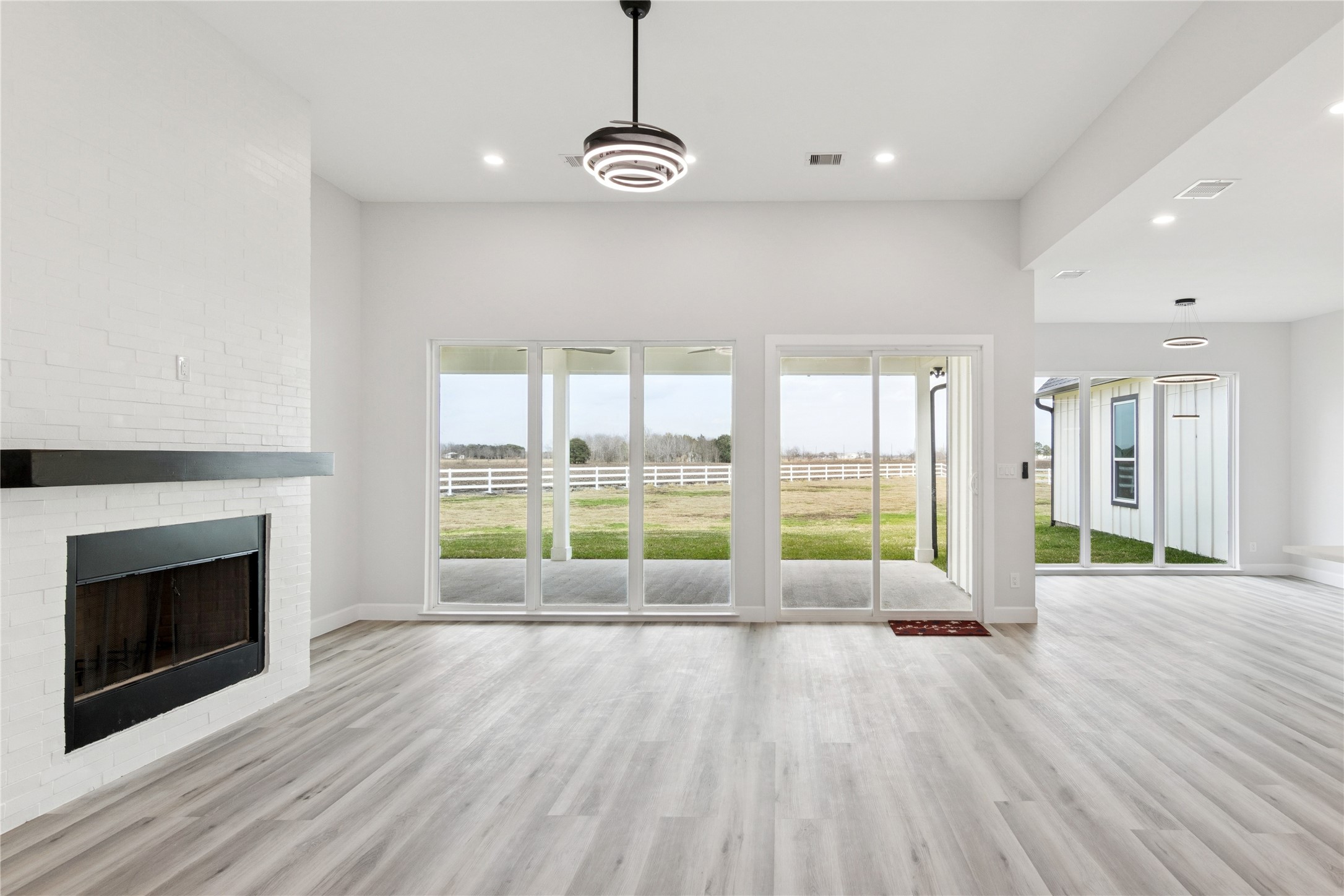 5766 Ward Bend Road Sealy, TX 77474 - Photo 7 of 45 a view of a livingroom with wooden floor and a fireplace