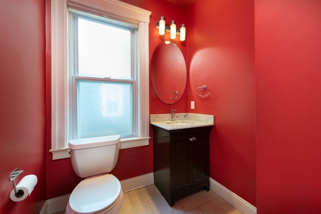 148 Albion Street, Unit 2 Somerville, MA 02144 - Photo 14 of 21 a bathroom with a toilet sink and mirror