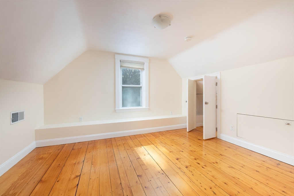 148 Albion Street, Unit 2 Somerville, MA 02144 - Photo 15 of 21 an empty room with wooden floor and windows
