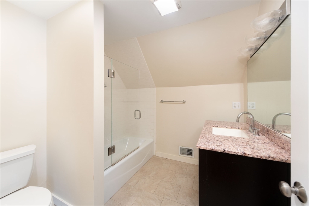 148 Albion Street, Unit 2 Somerville, MA 02144 - Photo 17 of 21 a bathroom with a granite countertop sink and a mirror