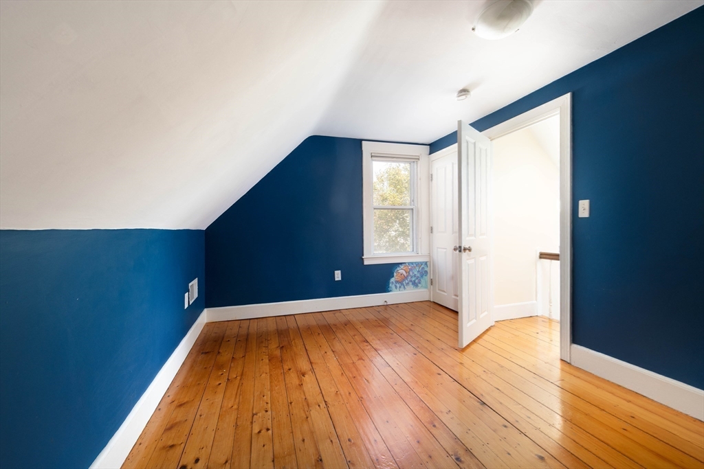 148 Albion Street, Unit 2 Somerville, MA 02144 - Photo 18 of 21 a view of a big room with wooden floor and windows