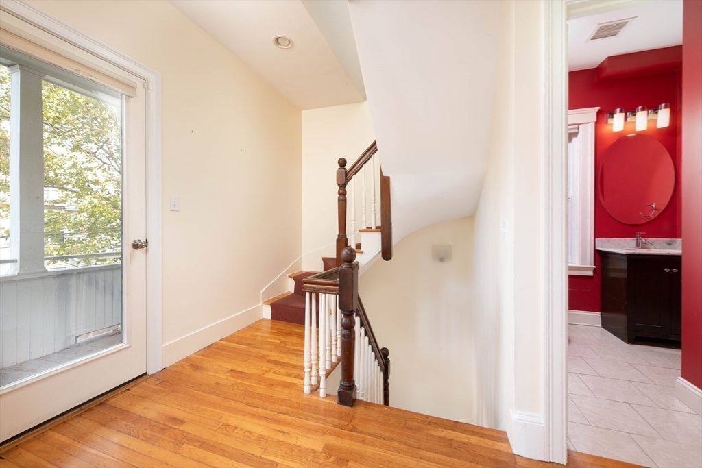 148 Albion Street, Unit 2 Somerville, MA 02144 - Photo 2 of 21 a view of a hallway with wooden floor and staircase
