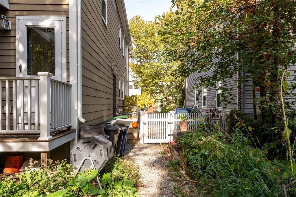 148 Albion Street, Unit 2 Somerville, MA 02144 - Photo 21 of 21 a backyard of a house with table and chairs and potted plants