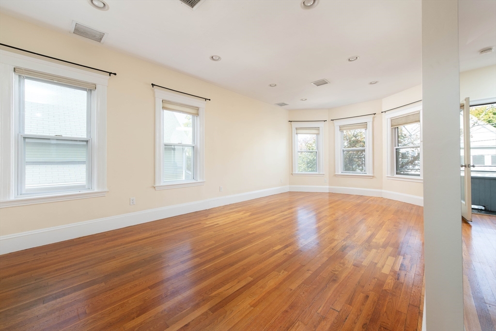148 Albion Street, Unit 2 Somerville, MA 02144 - Photo 4 of 21 a view of empty room with wooden floor and fan