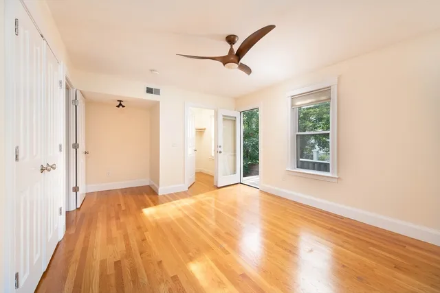 a view of a livingroom with a ceiling fan and window