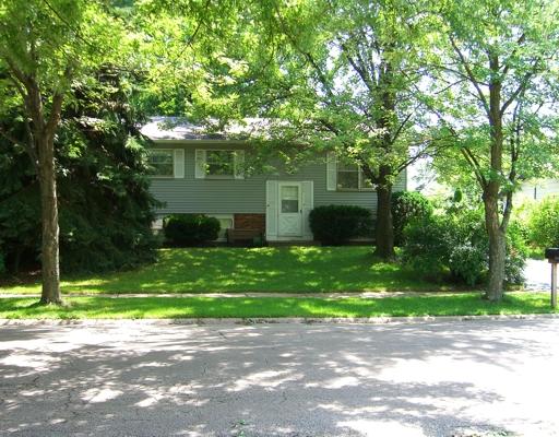 215 Hadleigh Road Bolingbrook, IL 60440 - Photo 1 of 1 a front view of a house with a garden and trees