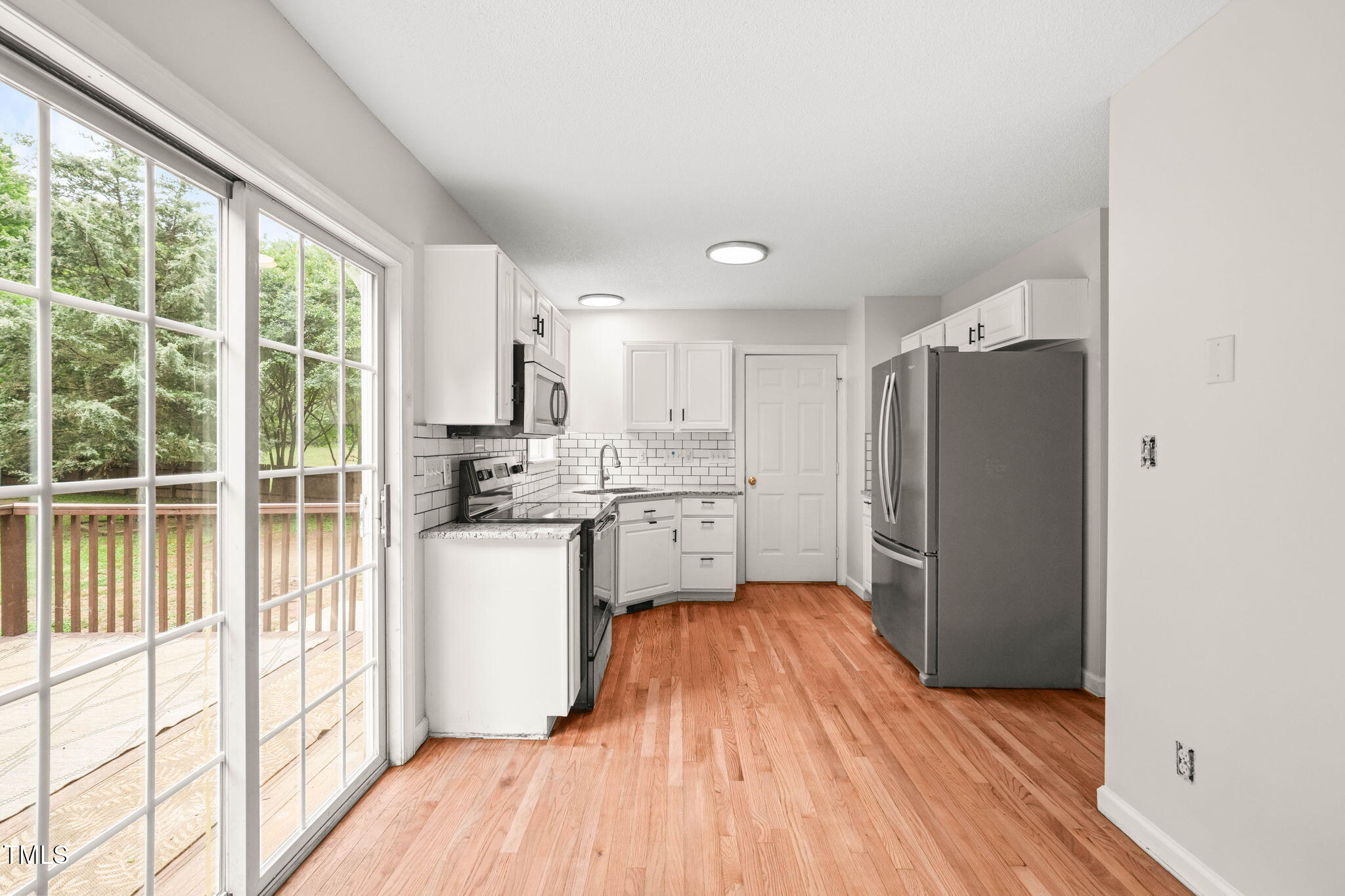 900 Borage Drive Wake Forest, NC 27587 - Photo 10 of 43 a kitchen with a refrigerator a sink and dishwasher with wooden floor