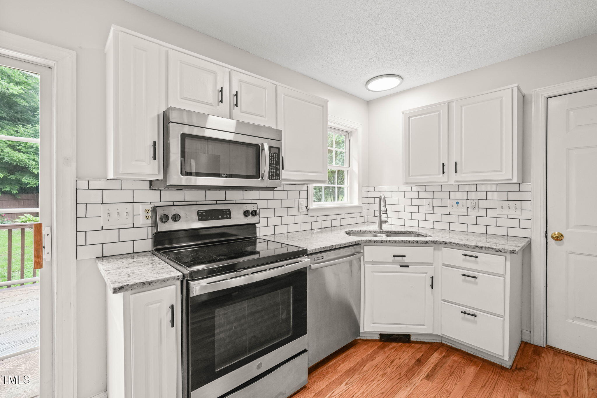 900 Borage Drive Wake Forest, NC 27587 - Photo 11 of 43 a kitchen with white cabinets stainless steel appliances and sink