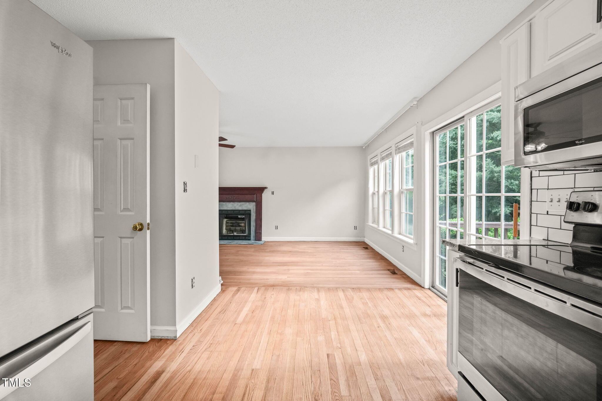 900 Borage Drive Wake Forest, NC 27587 - Photo 13 of 43 a view of a kitchen with wooden floor and electronic appliances