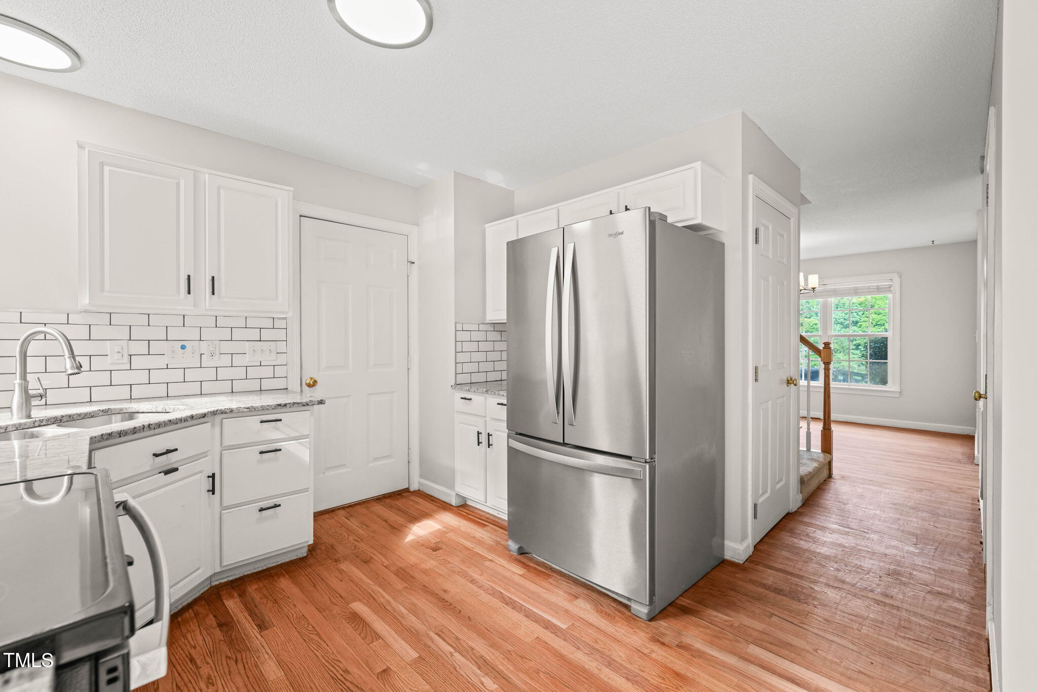 900 Borage Drive Wake Forest, NC 27587 - Photo 14 of 43 a kitchen with granite countertop a refrigerator sink and white cabinets