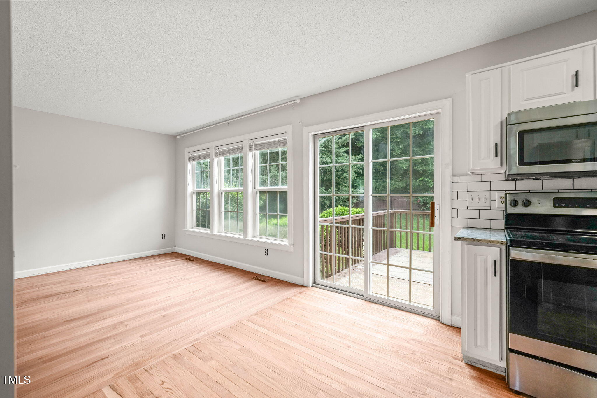 900 Borage Drive Wake Forest, NC 27587 - Photo 16 of 43 a view of empty room with wooden floor and fireplace