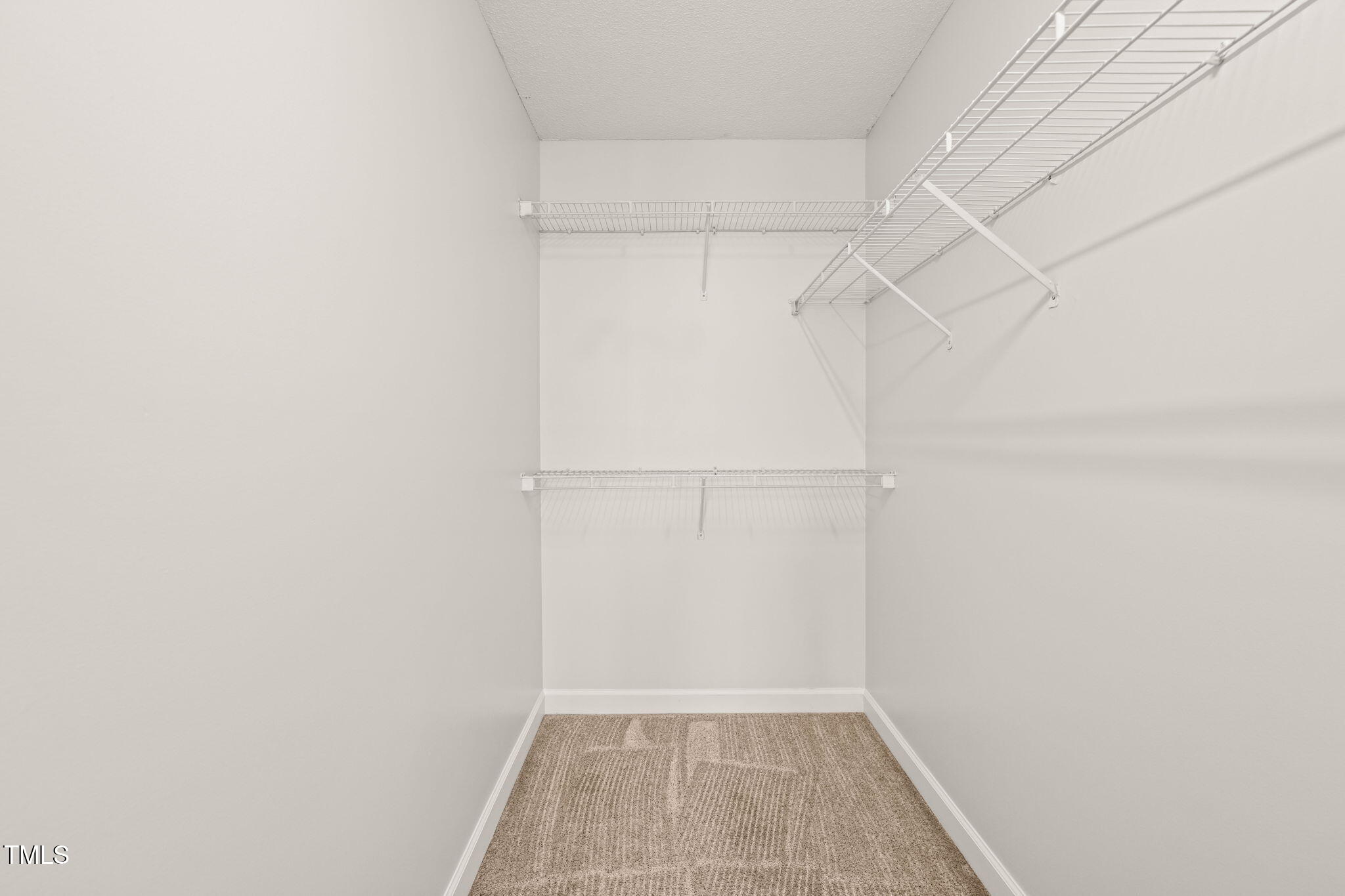 900 Borage Drive Wake Forest, NC 27587 - Photo 25 of 43 a view of a room with racks on the wall