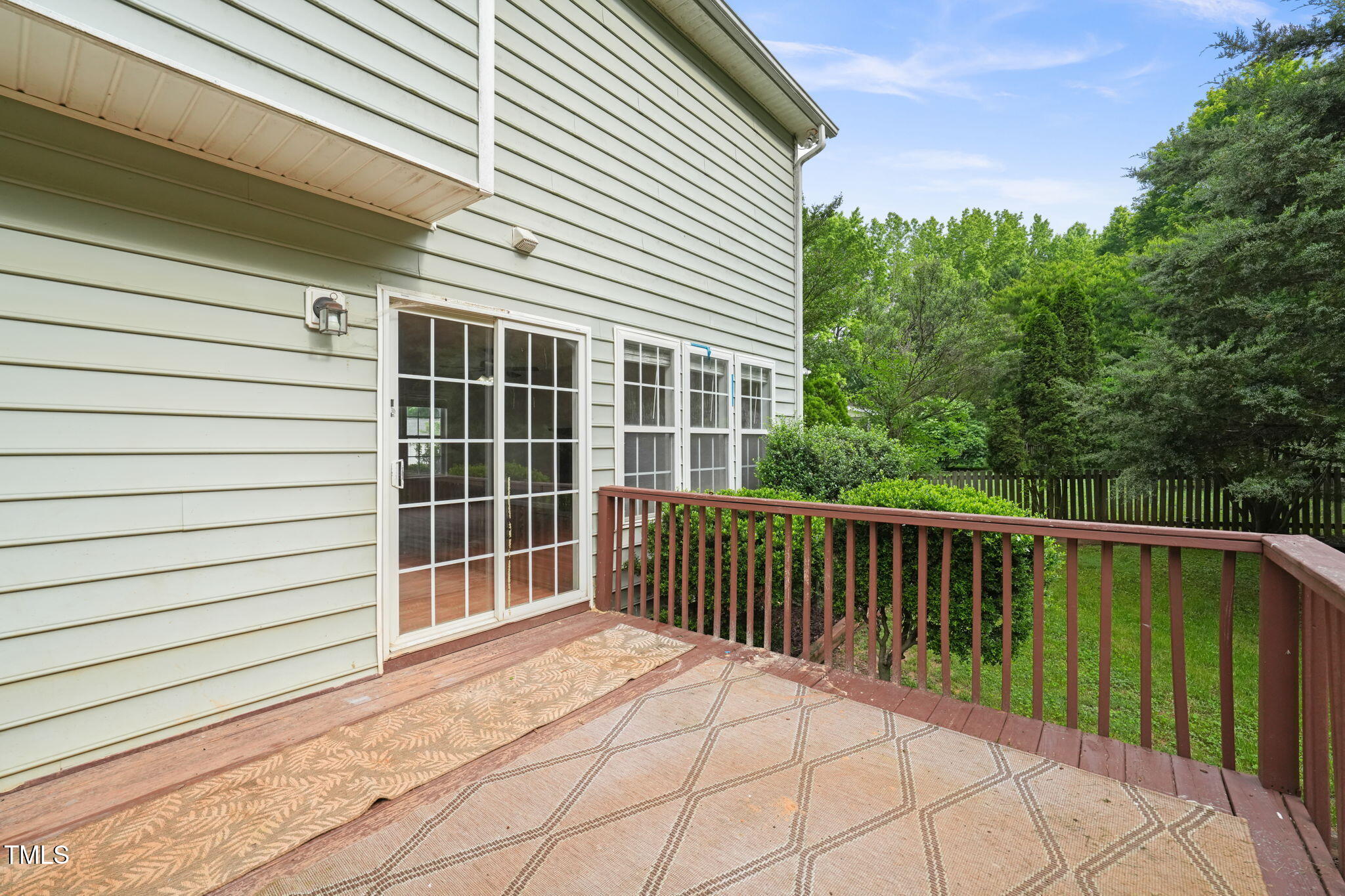900 Borage Drive Wake Forest, NC 27587 - Photo 33 of 43 a view of a balcony with a floor to ceiling window and wooden fence