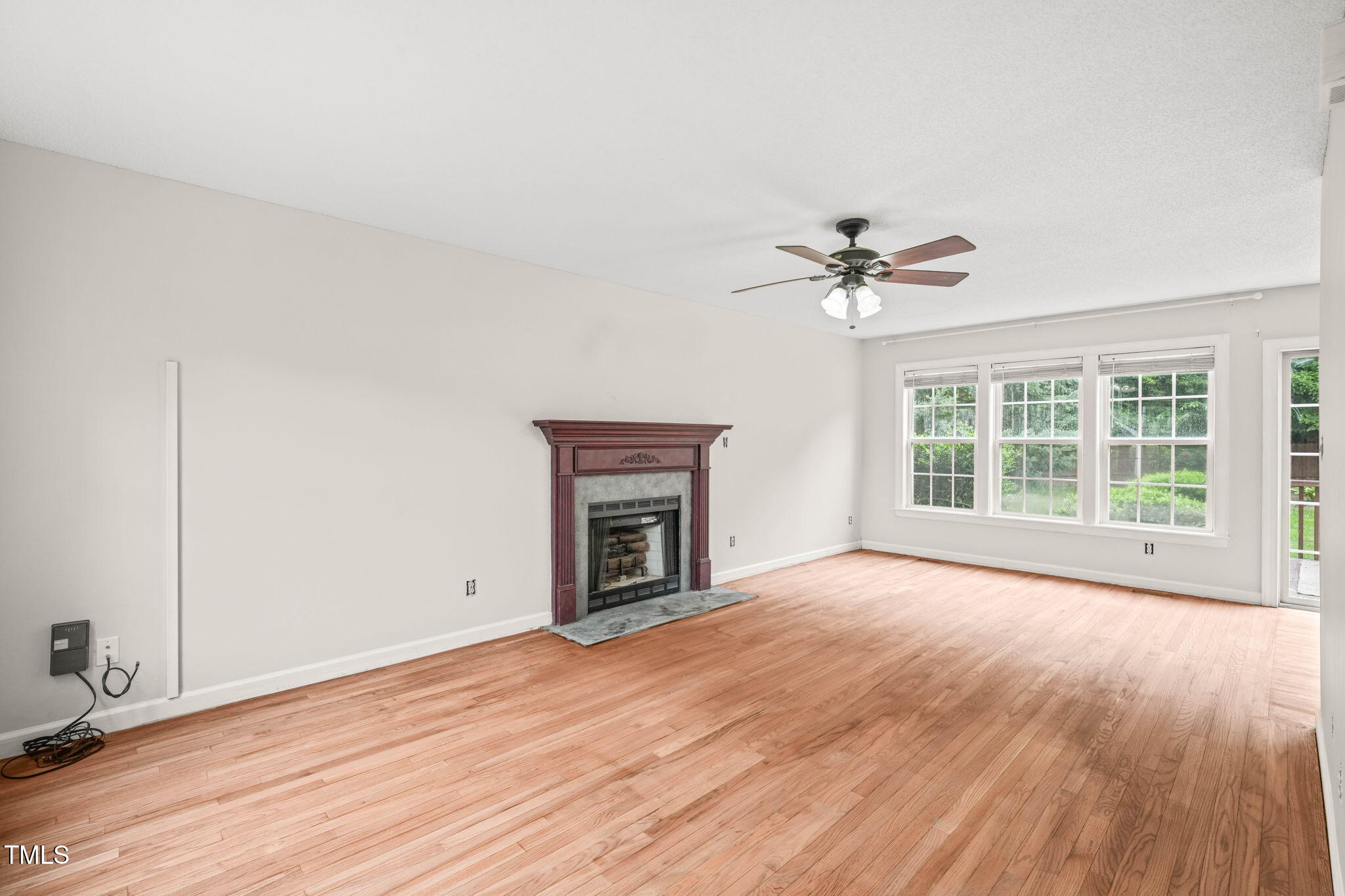 900 Borage Drive Wake Forest, NC 27587 - Photo 8 of 43 a view of an empty room with a window and wooden floor