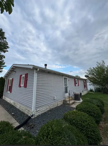 a backyard of a house with table and chairs