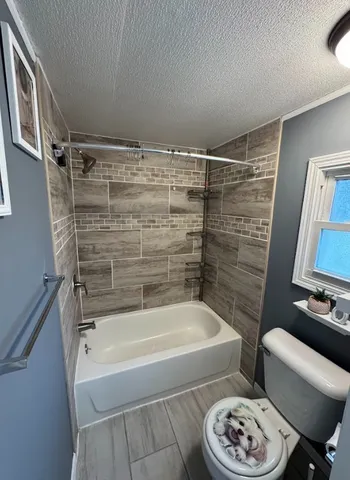 a bathroom with a bathtub and a toilet