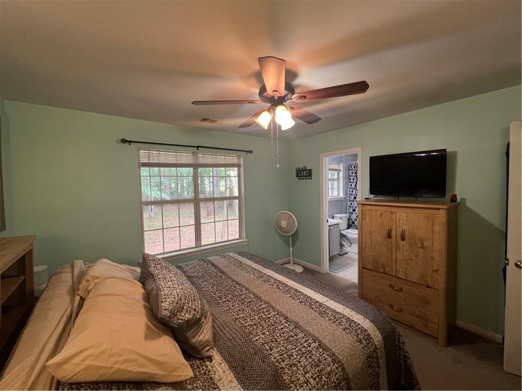 166 Barnetts Bridge Road Jackson, GA 30233 - Photo 13 of 29 a bedroom with a bed television on desk and a window