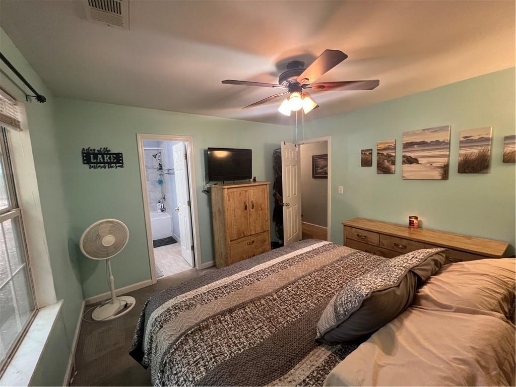 166 Barnetts Bridge Road Jackson, GA 30233 - Photo 14 of 29 a bedroom with a bed and a flat screen tv