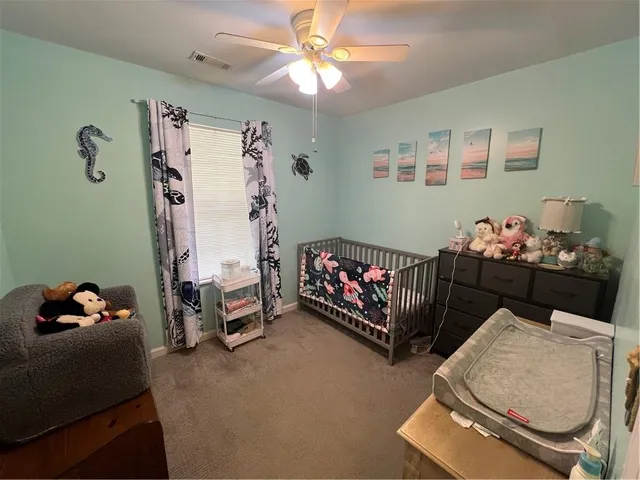a bedroom with bed and a chandelier