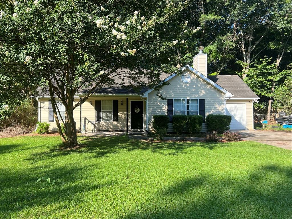 166 Barnetts Bridge Road Jackson, GA 30233 - Photo 2 of 29 a front view of a house with garden and porch