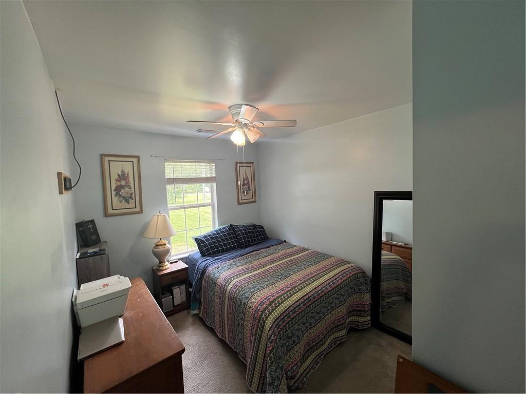 166 Barnetts Bridge Road Jackson, GA 30233 - Photo 21 of 29 a bedroom with a bed and a chandelier