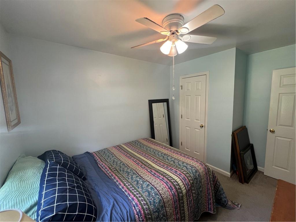 166 Barnetts Bridge Road Jackson, GA 30233 - Photo 22 of 29 a bedroom with a bed and a chandelier