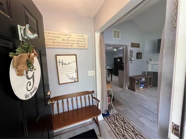 a view of living room with furniture and wooden floor