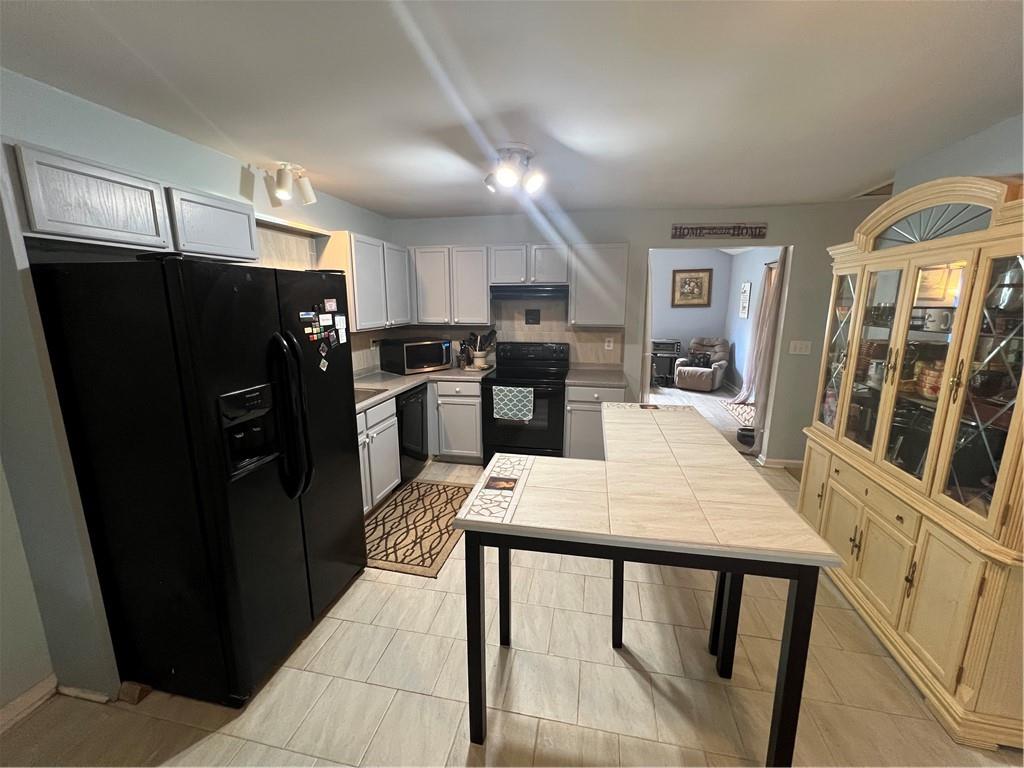 166 Barnetts Bridge Road Jackson, GA 30233 - Photo 10 of 29 a kitchen with stainless steel appliances wooden cabinets and wooden floor