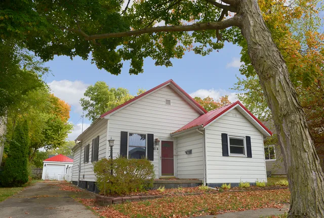 a view of a house with a tree in the background