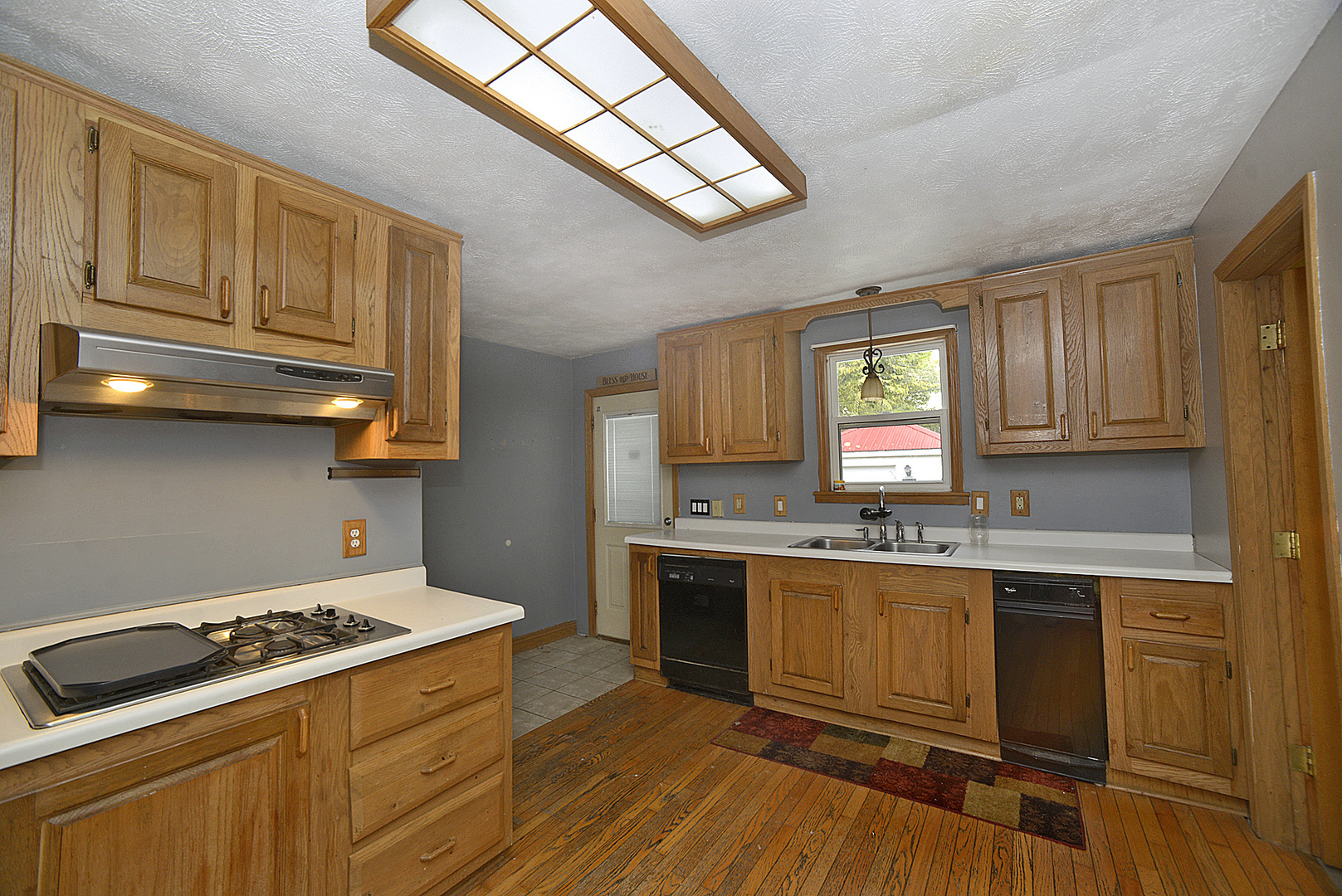 614 2nd Avenue Ottawa, IL 61350 - Photo 2 of 11 a kitchen with stainless steel appliances a stove a sink dishwasher and cabinets with wooden floor