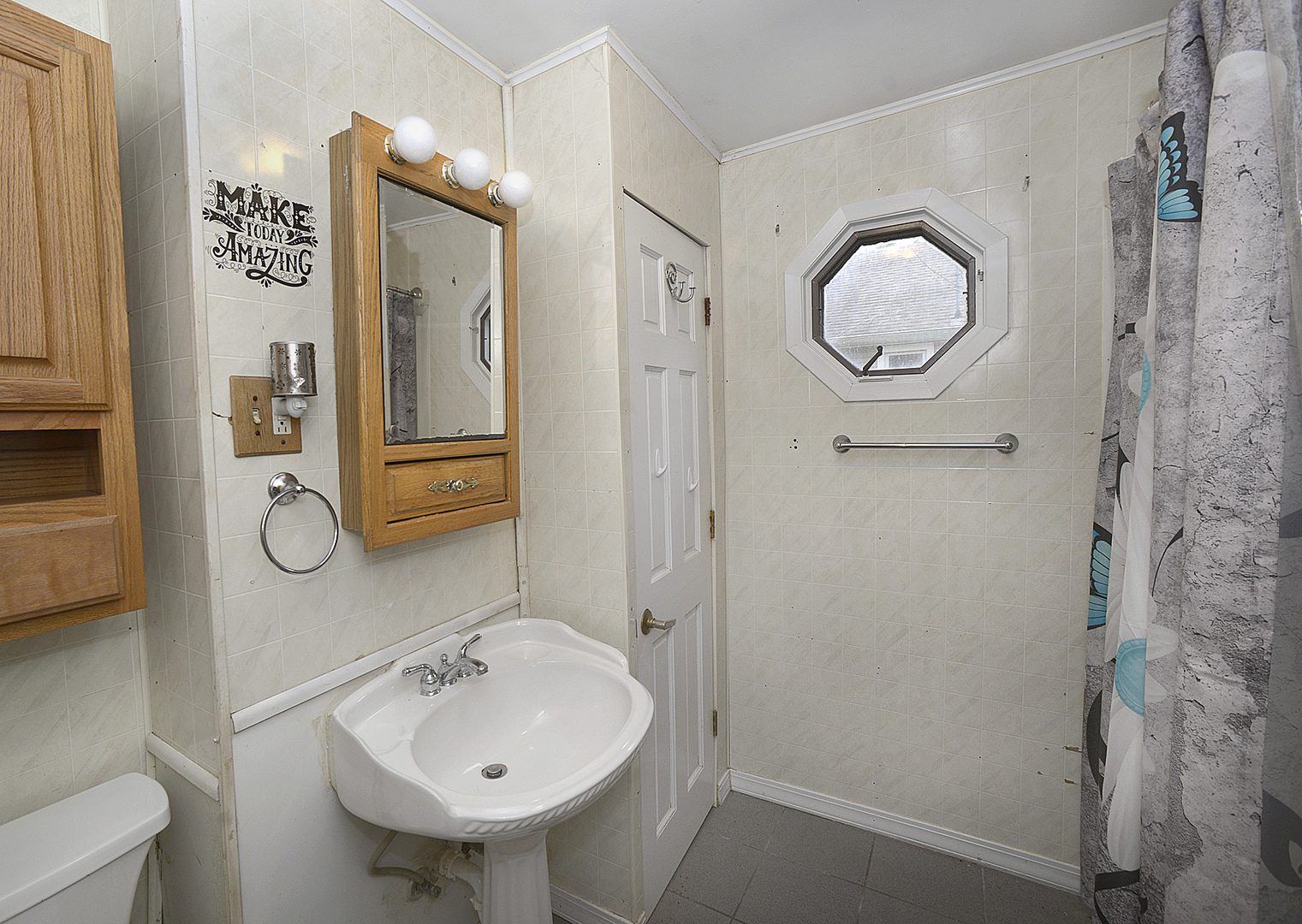 614 2nd Avenue Ottawa, IL 61350 - Photo 9 of 11 a bathroom with a sink mirror and vanity