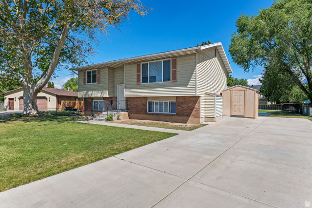 2402 710 North Provo, UT 84601 - Photo 12 of 15 Split-level residence featuring a light-colored siding and brick facade