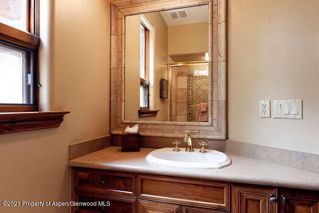 a bathroom with a sink and a mirror