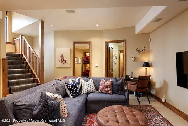 a living room with furniture a flat screen tv and a fireplace