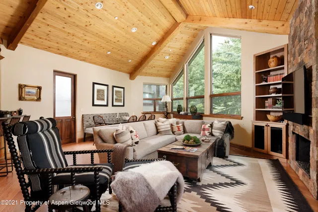 a living room with furniture a rug and a large window
