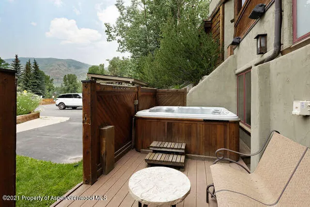 a backyard of a house with table and chairs