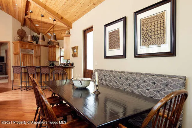 a view of a dining room with furniture and chandelier