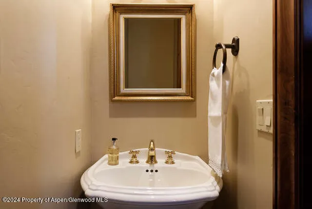 a bathroom with a sink and mirror