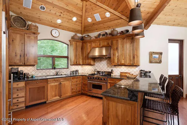 a kitchen with a sink a stove and cabinets