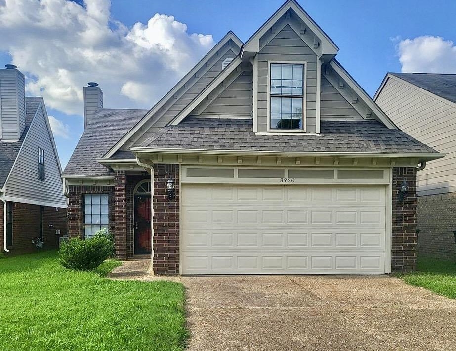 8326 Twin Rivers Drive Memphis, TN 38016 - Photo 1 of 21 Brick and siding exterior with a shingle roof and an integrated garage