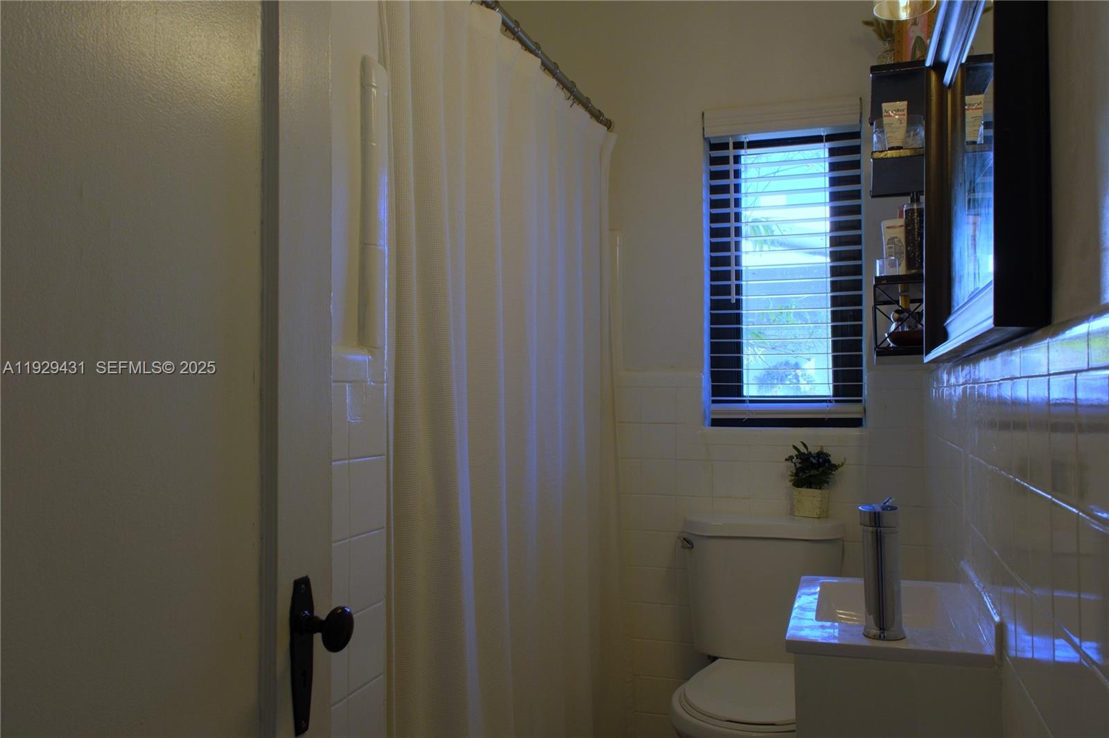 2818 Southwest 19th Street Miami, FL 33145 - Photo 20 of 43 a bathroom with a toilet a sink and a window