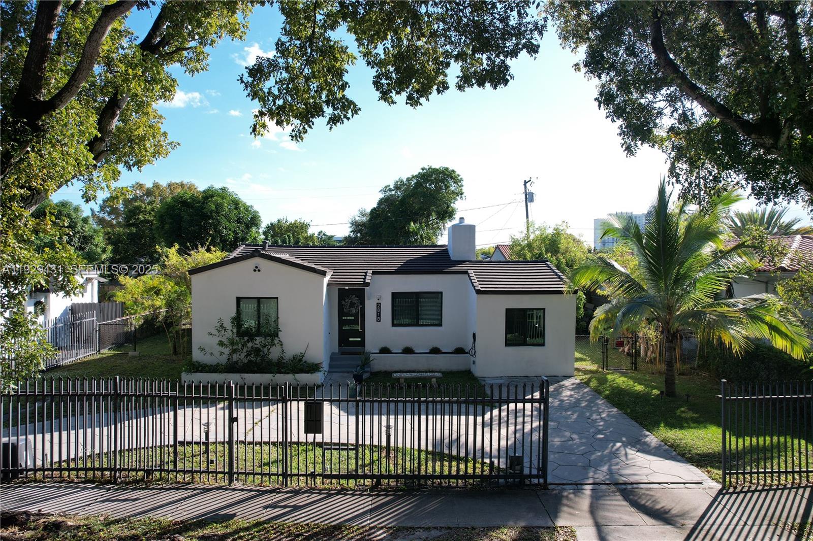 2818 Southwest 19th Street Miami, FL 33145 - Photo 2 of 43 a front view of a house with a garden