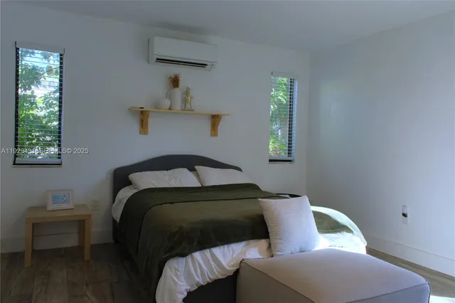 a view of room with wooden floor cabinet and mirror