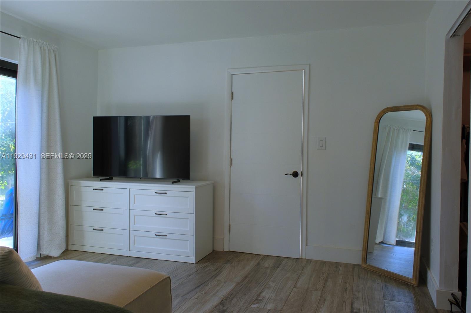 2818 Southwest 19th Street Miami, FL 33145 - Photo 26 of 43 a view of room with wooden floor cabinet and mirror