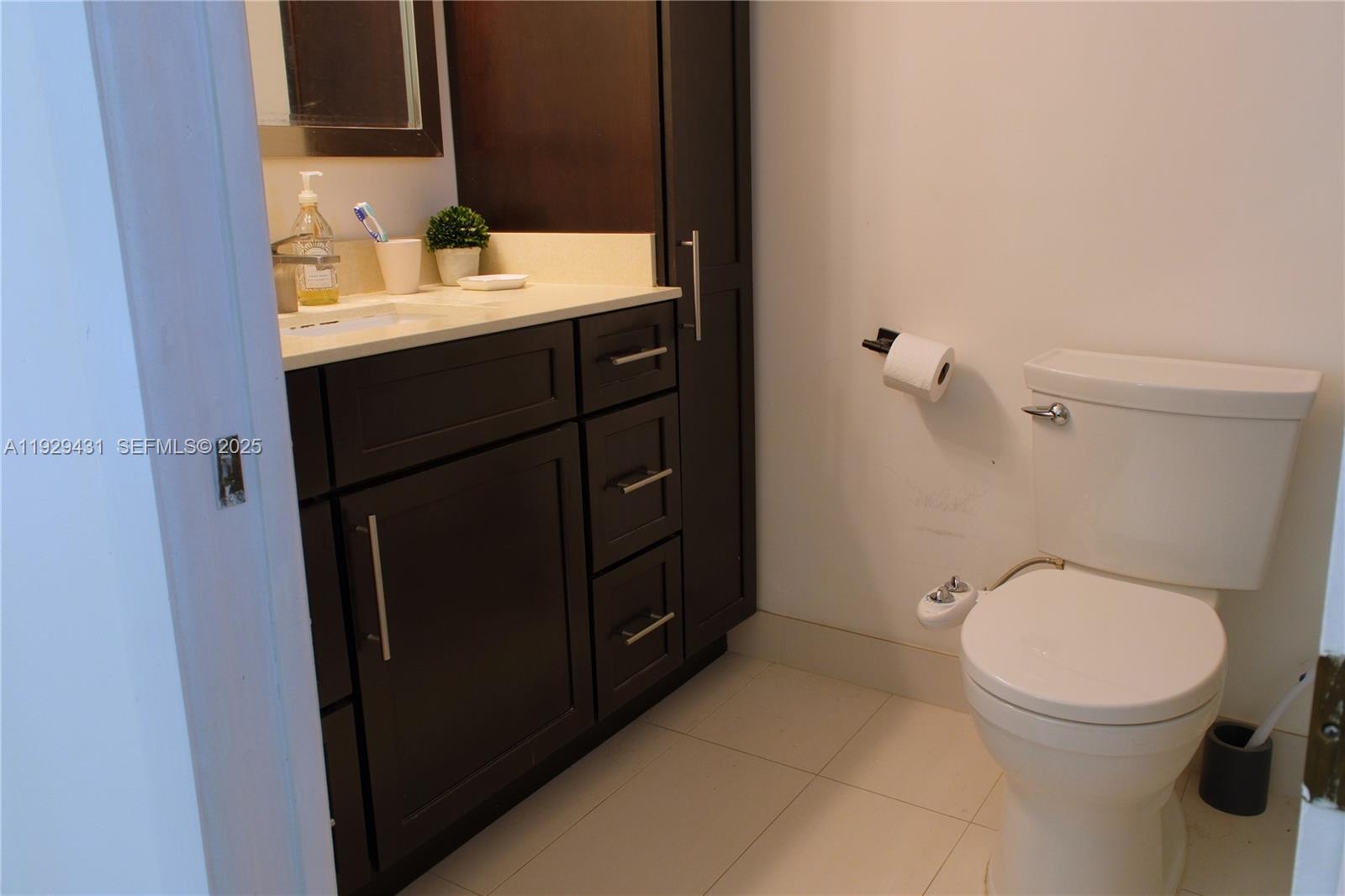 2818 Southwest 19th Street Miami, FL 33145 - Photo 27 of 43 a bathroom with a sink a toilet and mirror