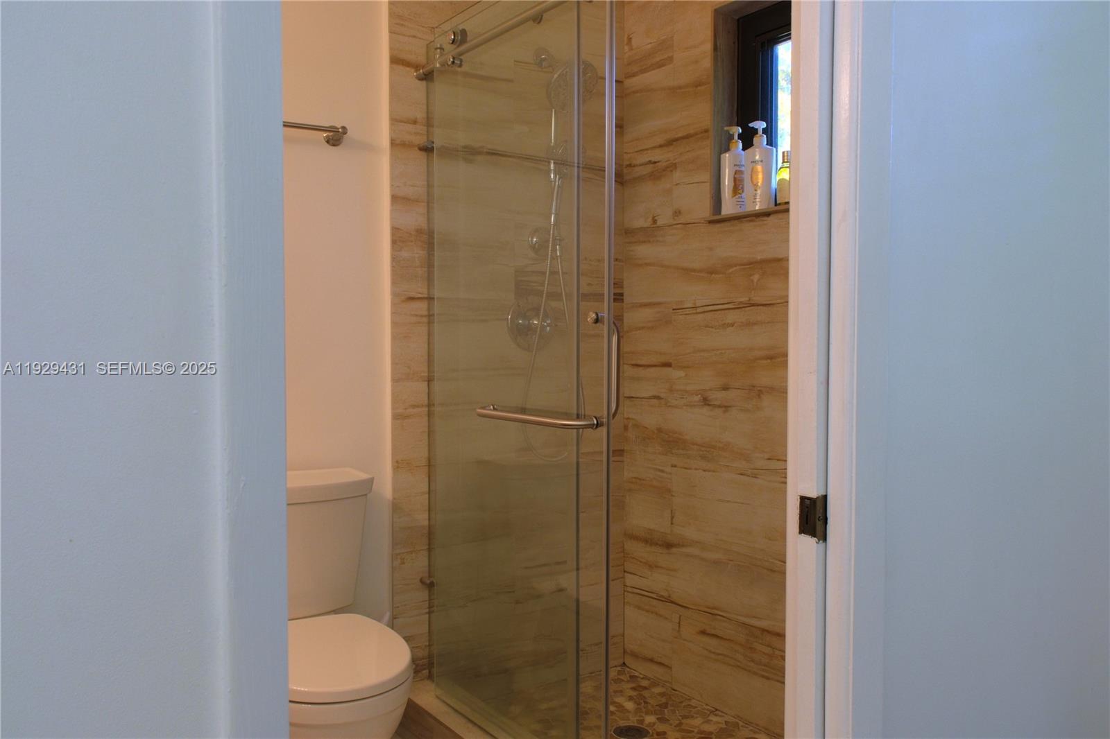 2818 Southwest 19th Street Miami, FL 33145 - Photo 28 of 43 a bathroom with a shower and a toilet
