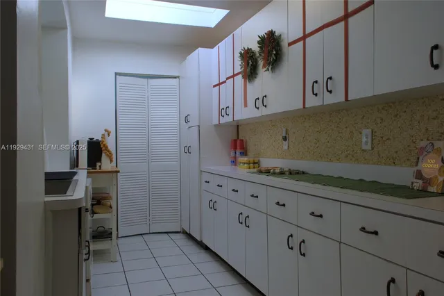 a kitchen with a refrigerator and cabinets