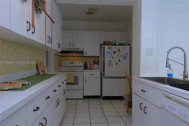 a utility room with sink dryer and washer