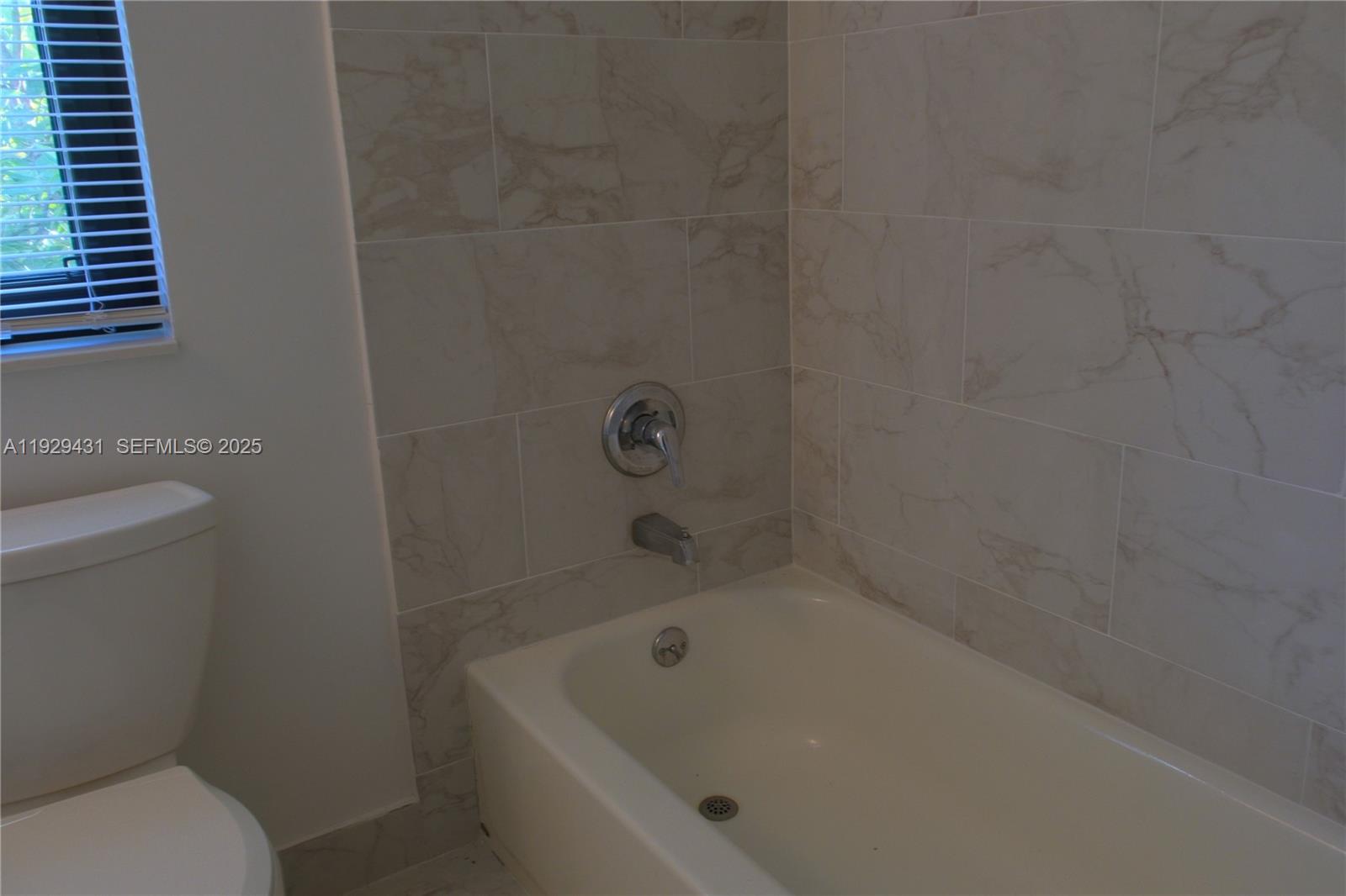 2818 Southwest 19th Street Miami, FL 33145 - Photo 37 of 43 a white bath tub sitting next to a toilet