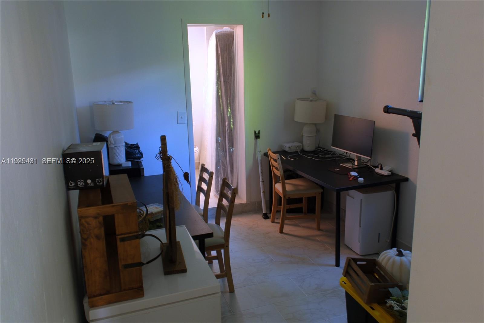 2818 Southwest 19th Street Miami, FL 33145 - Photo 38 of 43 a view of a workspace with furniture and a gate